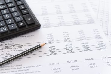 accounting spread sheets balance sheet and calculator on accountant's desk. Accounting , accounts concept. above view.